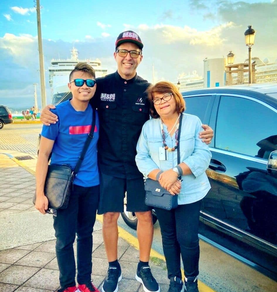 Carlos Alexis with two guests beside his vehicle in Old San Juan